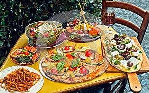 A summer dinner .Traditional italian food in outdoor restaurant in Trastevere district in Rome, Italy