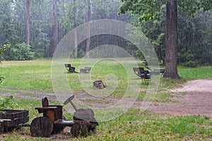 Summer downpour on an empty playground among the trees