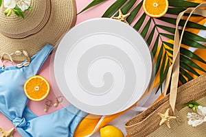 Summer dreams! Top view flat lay of blue swimsuit with sunhat, green palm leaves, earrings, bracelet, and bag on pastel pink