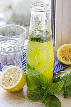 Summer drink with lemon, basil and soda