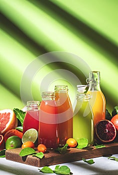 Summer drinks. Citrus fruit juices, fresh and smoothies, food background. Mix of different whole and cut fruits: orange,