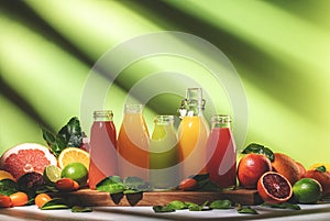 Summer drinks. Citrus fruit juices, fresh and smoothies, food background. Mix of different whole and cut fruits: orange,