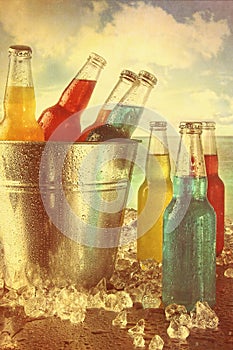 Summer drinks in ice bucket at the beach with vintage look