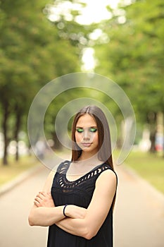 Summer emotional portrait of a beautiful girl with makeup on the street