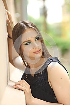 Summer emotional portrait of a beautiful girl with makeup on the street