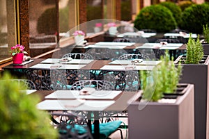 Summer empty open air restaraunt in italian city in Europe. Closeup wineglasses on the table