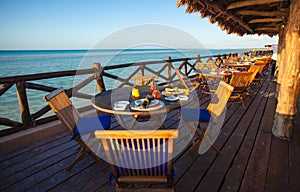 Summer empty open air restaraunt near sea at