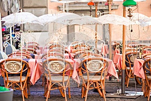 Summer empty open air restaraunt in Pisa in Italy. Closeup wineglasses on the table