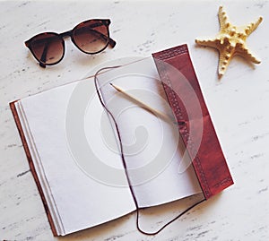 Summer essentials on white marble.