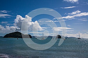 Summer evening at Bay of Islands. Leisure boats scattered on sparkling water. Northland, New Zealand