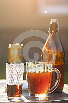 Summer evening. Colored drinks in various glassware on the outdoor table, a party in the backyard house with cold drinks, A set
