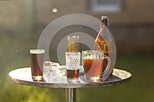 Summer evening. Colored drinks in various glassware on the outdoor table, a party in the backyard house with cold drinks, A set