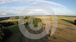 Summer evening landscape with crop fields and electrical tower aerial view from drone