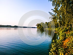 Summer evening shore of a large lake