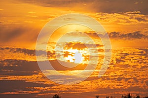 summer evening, sunset in yellow, orange and pink with clouds