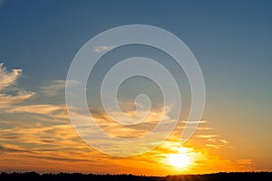 summer evening, sunset in yellow, orange and pink with clouds