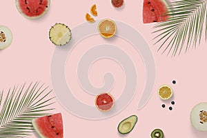 Summer exotic fruit top view flatlay with green palm leaves. Sliced watermelon