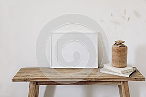 Summer, fall still life photo. Vase with dry lagurus, bunny tail grass in ceramic vase. Old wooden bench. Blank