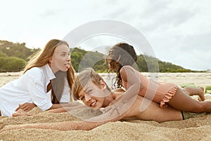 Summer. Family On Beach Having Fun. Mother And Little Girl Making Funny Faces Brother. Young Woman With Children.