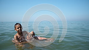 Summer family fun, son play with father puting his head underwater drowning