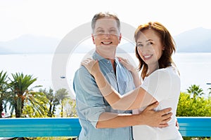 Summer family vacation. Happy middle aged couple having fun on travel holidays weekend. Sea and beach background. Copy space.