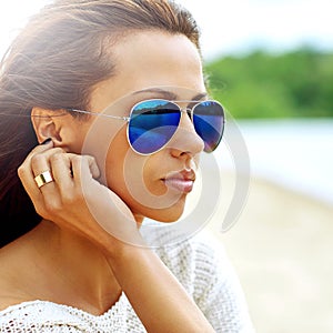 Summer fashion portrait of beautiful woman in sunglasses - close up