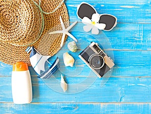 Summer Fashion woman big hat and accessories, camera and sunglasses go to travel in the beach. Tropical sea.Unusual top view, bac