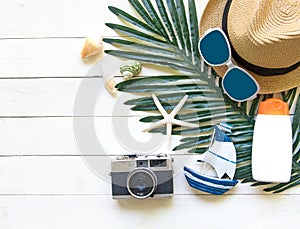 Summer Fashion woman big hat and accessories, camera and sunglasses go to travel in the beach. Tropical sea.Unusual top view, bac