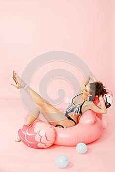 Summer Fashion. Woman Model In Swimsuit On Flamingo