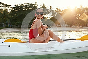 Summer Fashion. Woman In Red Swimwear And Sunglasses On Kayak