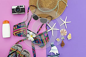 Summer Fashion woman swimsuit Bikini, camera, starfish, sunblock, sun glasses, hat. Travel in the holiday colorful background