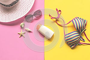 Summer Fashion woman swimsuit Bikini, camera, starfish, sunblock, sun glasses, hat. Travel in the holiday pastel background