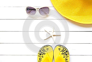 Summer Fashion woman yellow big hat and accessories in the beach. Tropical sea.Unusual top view, colorfull background