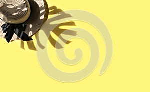 Summer flat lay. Straw hat monstera leaf shadow