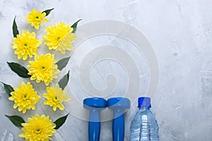 Summer flatlay composition with sport equipment and flowers.