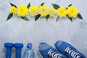 Summer flatlay composition with sport equipment and flowers.