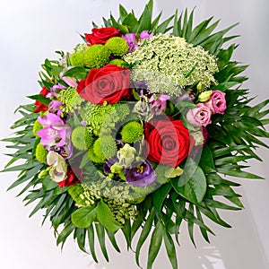Summer flowers in arrangement, luxury bouquet with beautiful red roses, carrot umbel and sweetwilliams photo