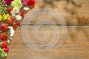 Summer Flowers and Berries on Grunge Wood Table