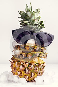 Summer Food Concept Fresh Sliced Pineapple With Ice Cube on White Background Pineapple and Sunglass Toned