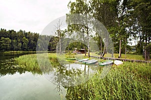 Summer forest landscape with lake and boats photo