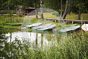 Summer forest landscape with lake and boats photo