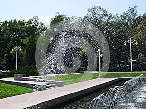 Summer fountain and blue sky and water in the park