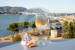 Summer on French Riviera, cold white or gris rose wine from Cotes de Provence on outdoor terrase with view on harbour