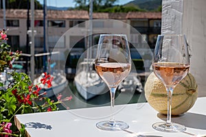 Summer on French Riviera Cote d`Azur, cold rose wine from Cotes de Provence on outdoor terrase in Port Grimaud, Var,