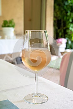 Summer on French Riviera Cote d`Azur, drinking cold rose from Cotes de Provence on outdoor terrase in old cafe, Var, France