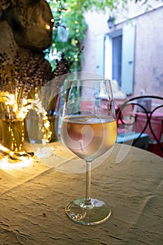 Summer on French Riviera Cote d`Azur, drinking cold rose from Cotes de Provence on outdoor terrase in old cafe, Var, France