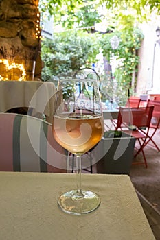 Summer on French Riviera Cote d`Azur, drinking cold rose from Cotes de Provence on outdoor terrase in old cafe, Var, France