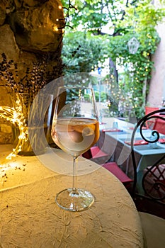 Summer on French Riviera Cote d`Azur, drinking cold rose from Cotes de Provence on outdoor terrase in old cafe, Var, France