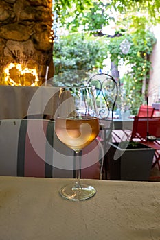 Summer on French Riviera Cote d`Azur, drinking cold rose from Cotes de Provence on outdoor terrase in old cafe, Var, France