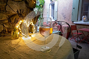 Summer on French Riviera Cote d`Azur, drinking cold rose from Cotes de Provence on outdoor terrase in old cafe, Var, France